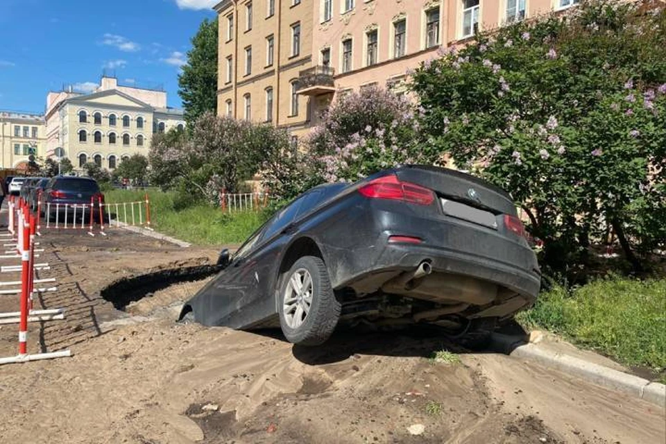 Машина провалилась в яму на Дровяной улице в центре Петербурга