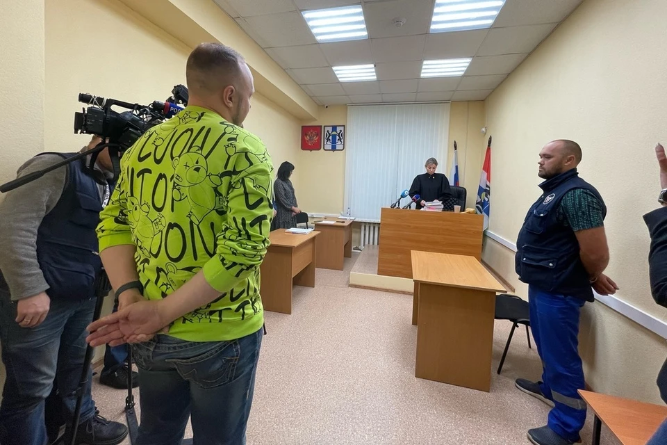 В Новосибирске отец больного ребенка (в яркой кофте), избивший врача за отказ надеть бахилы, выплатит медику 50 тысяч рублей.