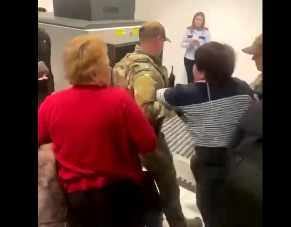 Спецназ, который участвовал в "обычной" проверке в аэропорту прилетевших из Москвы, силой утащил куда-то женщину. Фото: скриншот видео