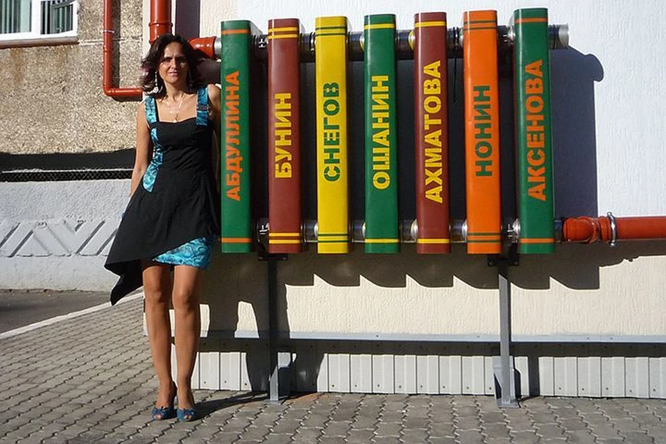 Художница Марина Звягинцева около паблик-арт объекта "Вечная теплота", установленного на фасаде Публичной библиотеки Норильска